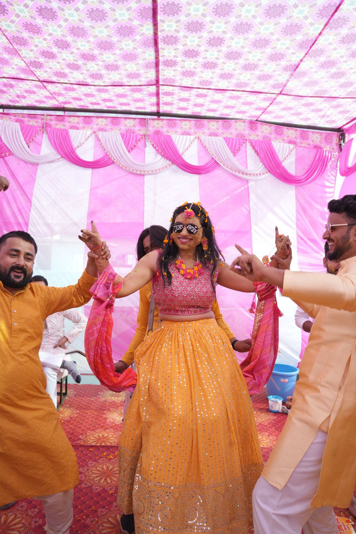 A bride dancing with family