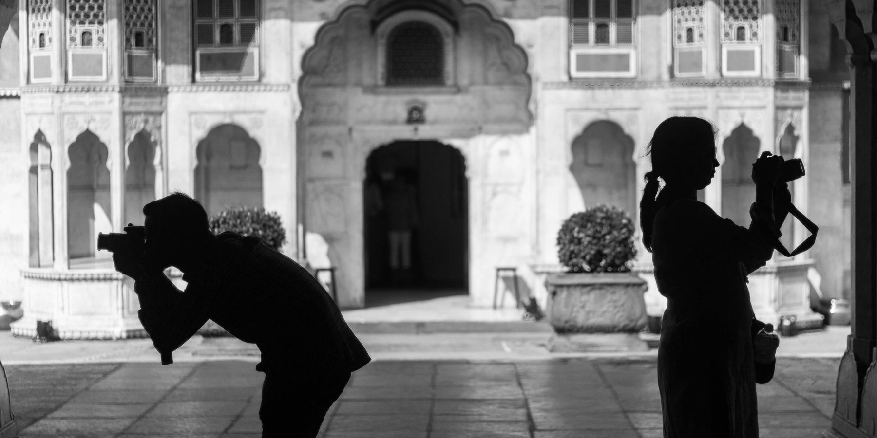 Two wedding photographers at work in a courtyard