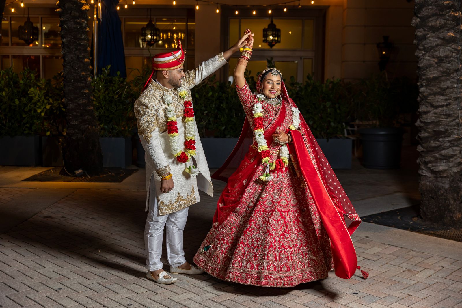 A couple dancing in a courtyard at night